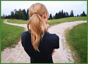 Person choosing path at rural fork