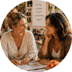 Two women smiling and planning over papers